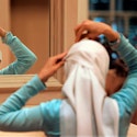 Sadaf Butt, of Alabama, adjusts her hijab in a mirror at the 43rd annual Islamic Society of North America convention, Friday, Sept, 1, 2006, in Rosemont, Ill. The four-day convention will focus on a range of issues facing American Muslims and their evolving role and identity in the American society. (AP Photo/M. Spencer Green)